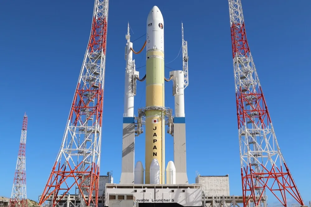 A Japanese rocket on its launch pad under a blue sky