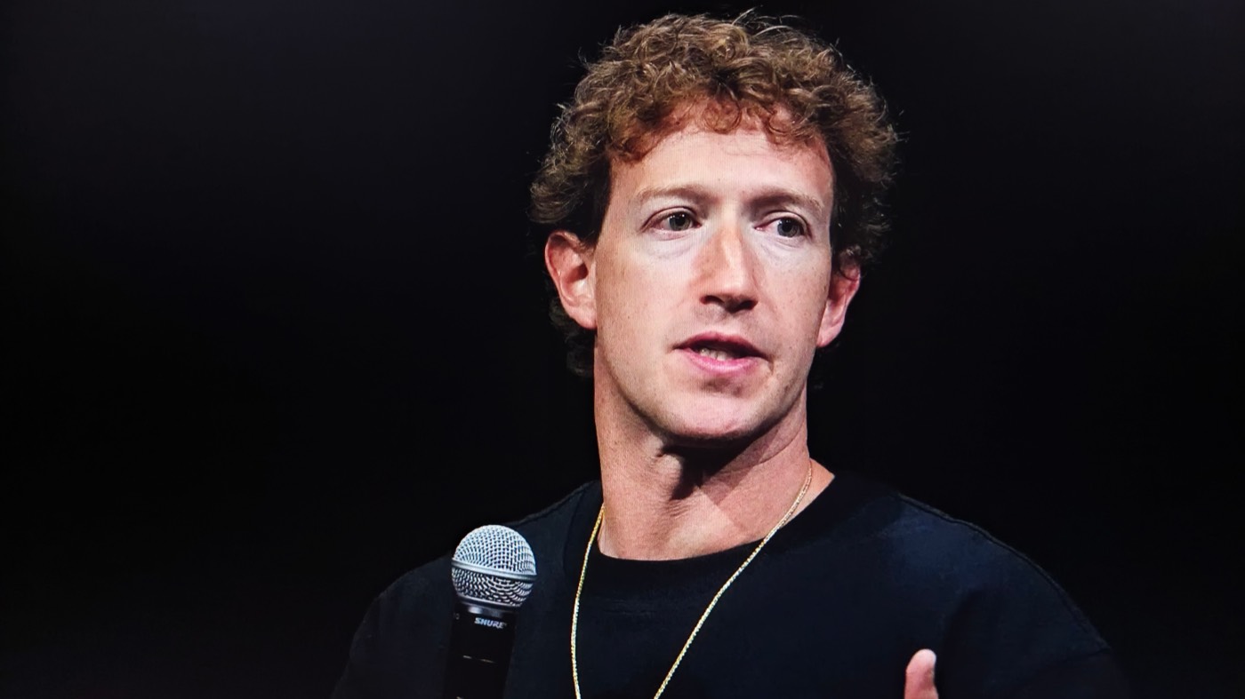 Mark Zuckerberg speaking on stage with a microphone
