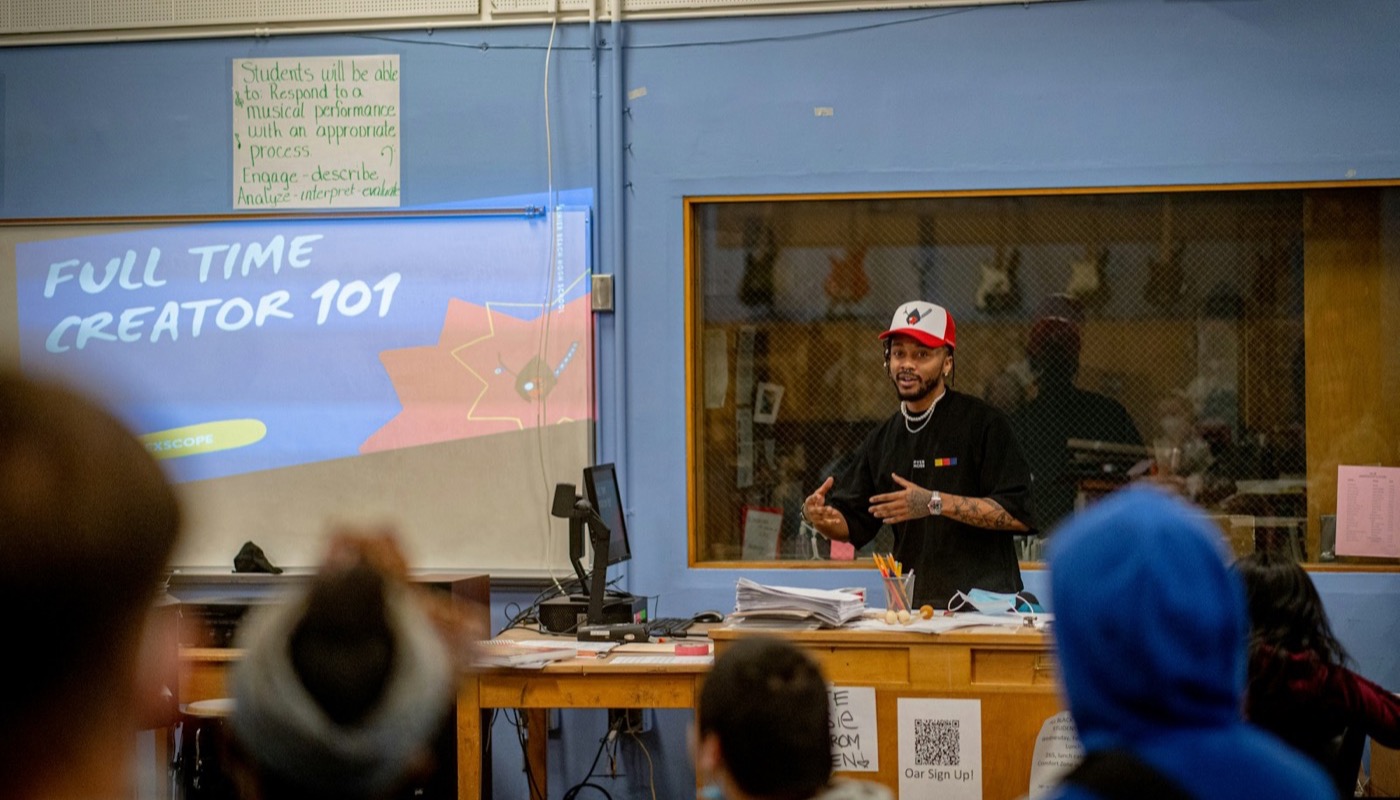 A presenter leading a classroom session as students watch