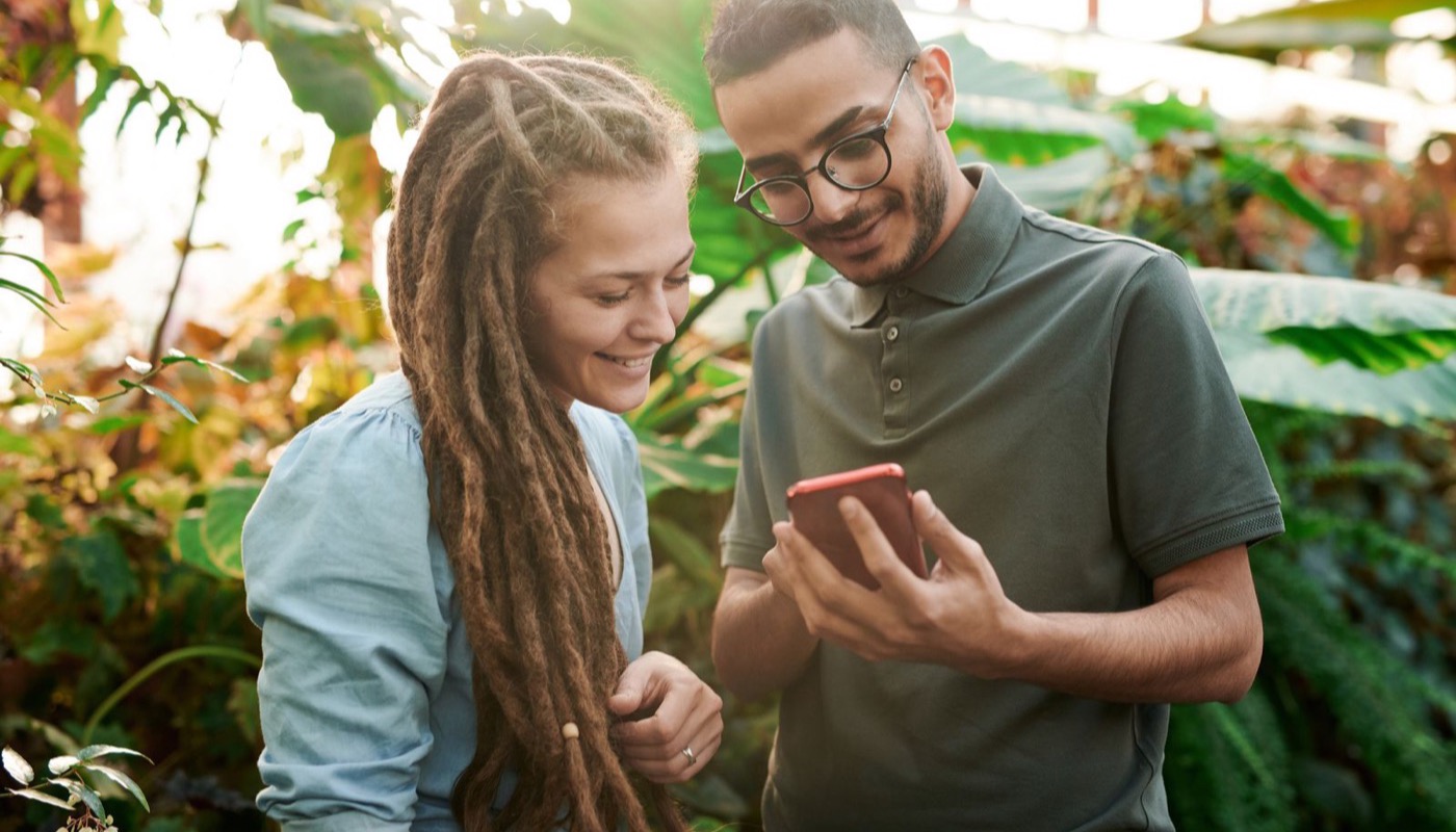 Two people looking at news on a smartphone together