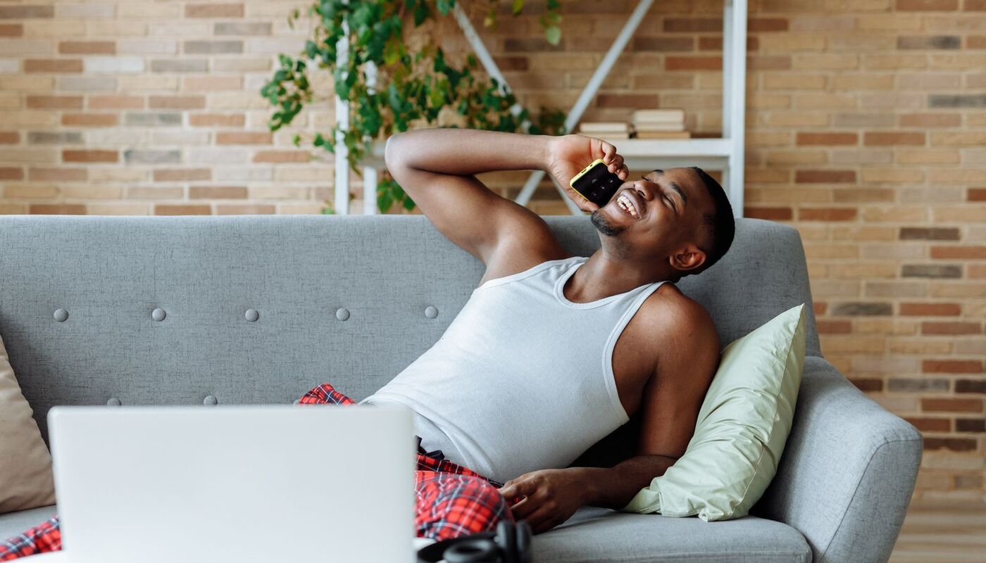 A person using a phone on a couch