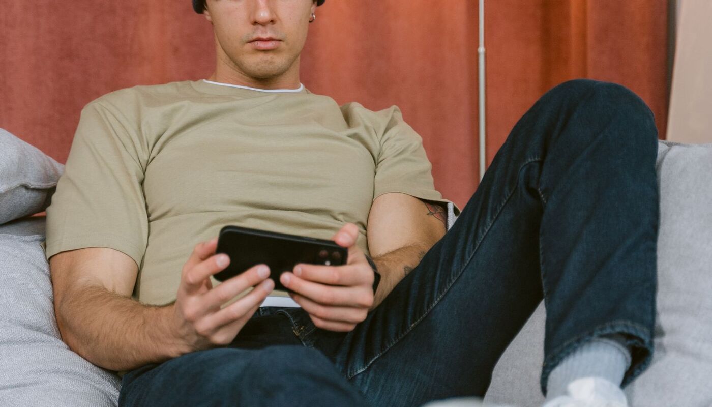 A person reading a news app on a phone