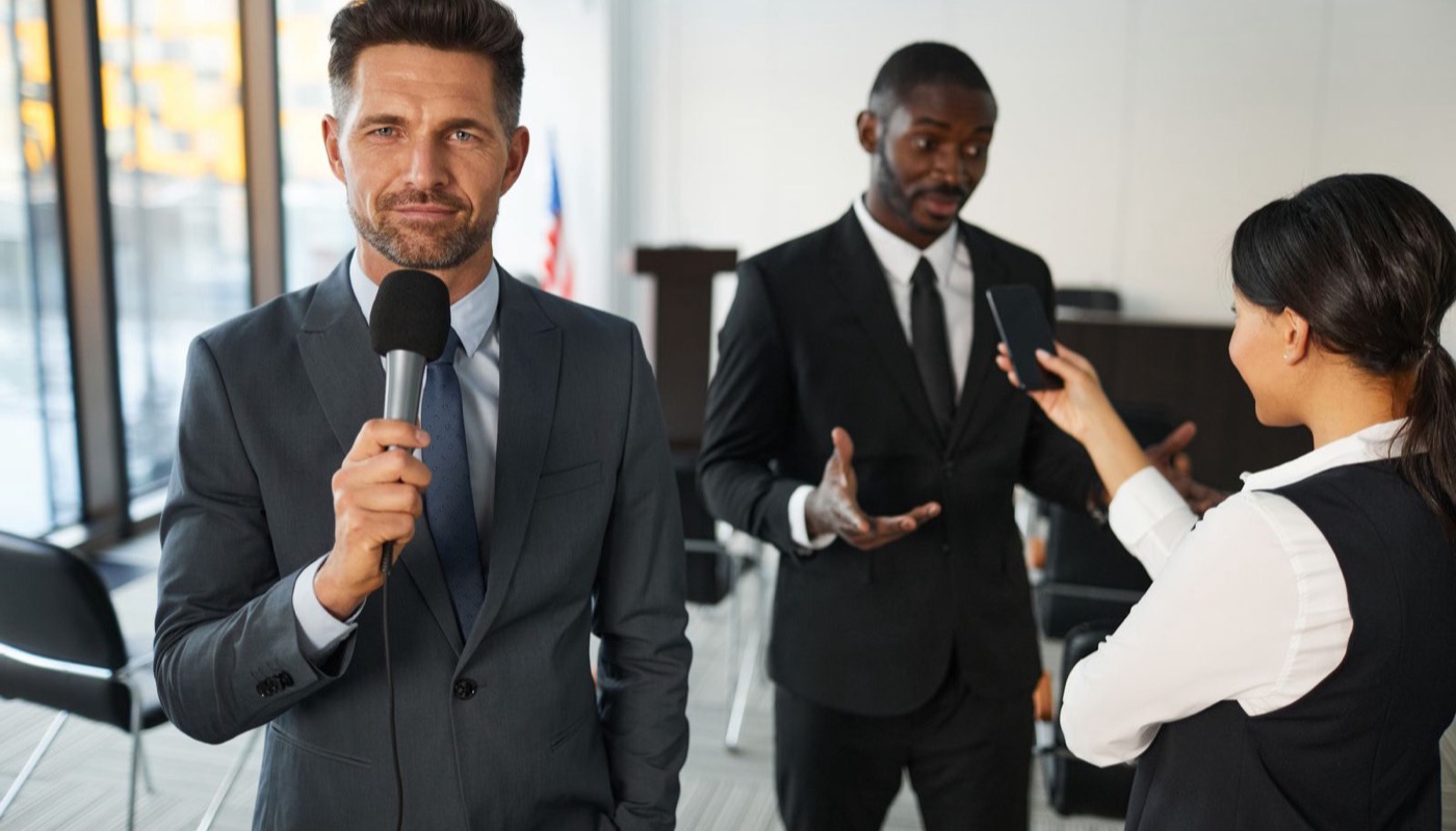A television reporter interviewing people at an event