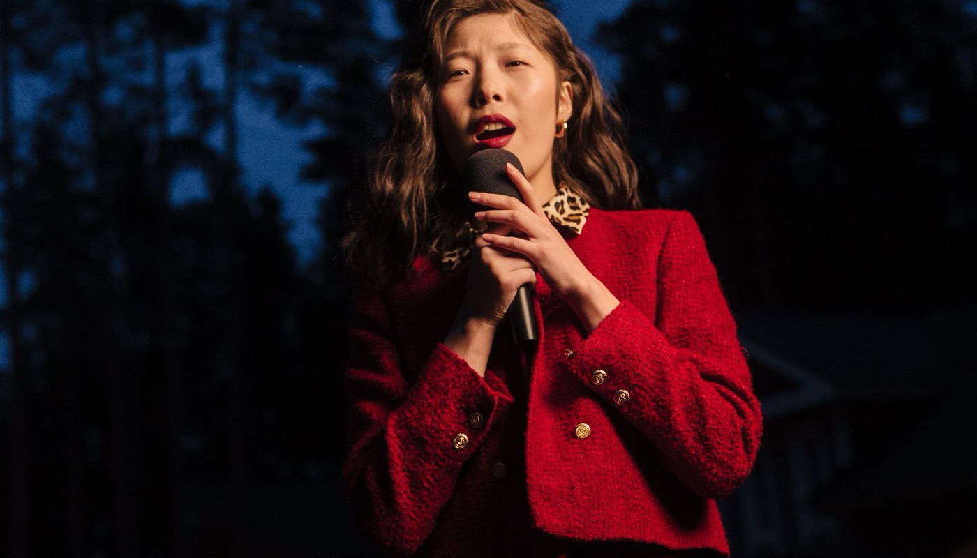 A reporter holding a microphone while covering a story