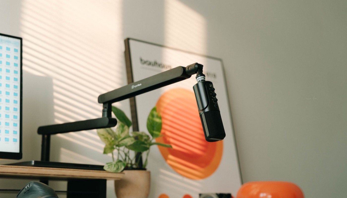 A home office desk set up with a microphone for recording
