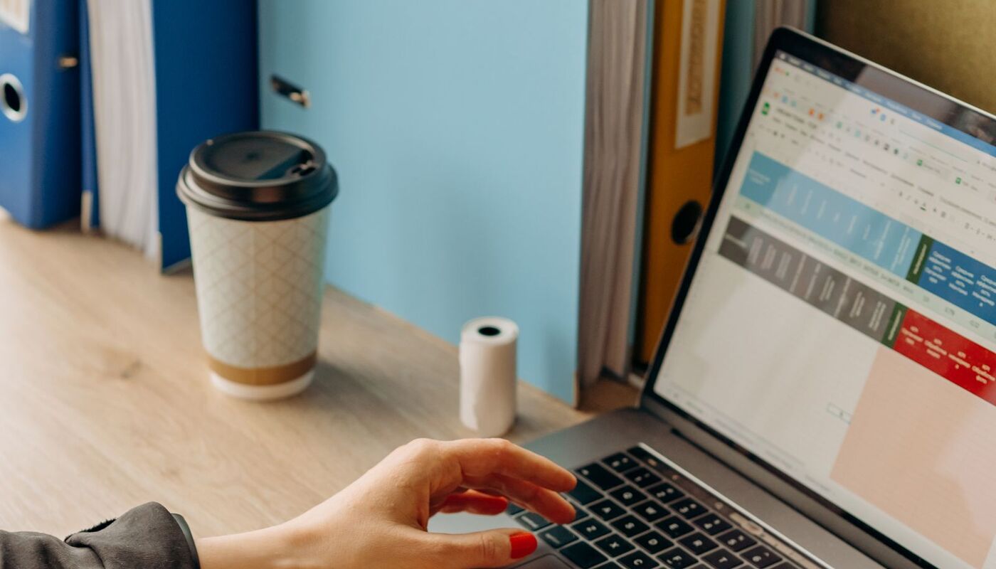 A person working at a laptop at a desk