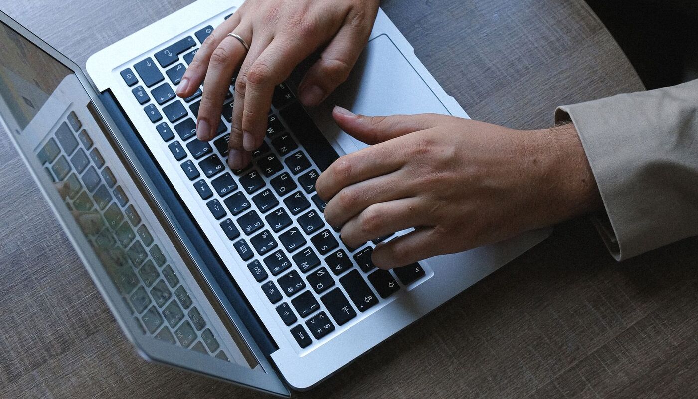 A person working on a laptop at a table