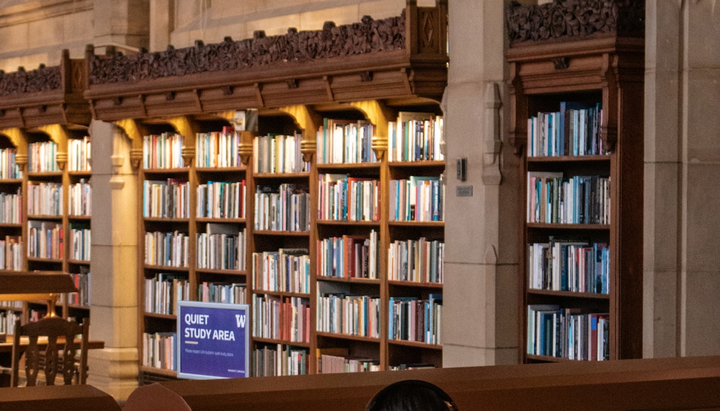 The bookshelves of a university library reading room
