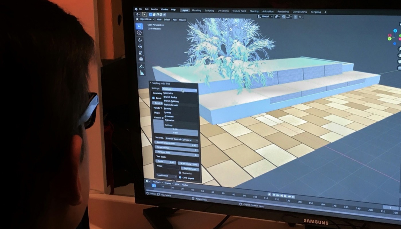 A person working at a computer screen with 3D graphics software