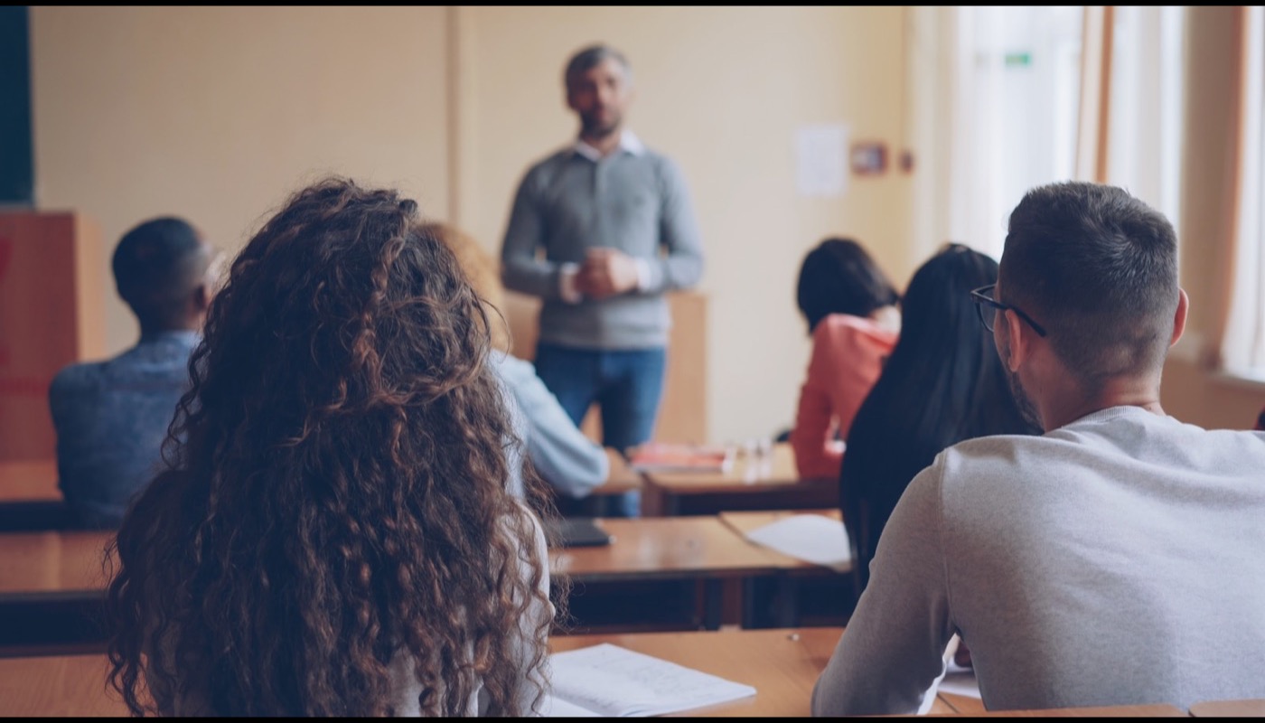 A teacher leading a discussion with students in a classroom