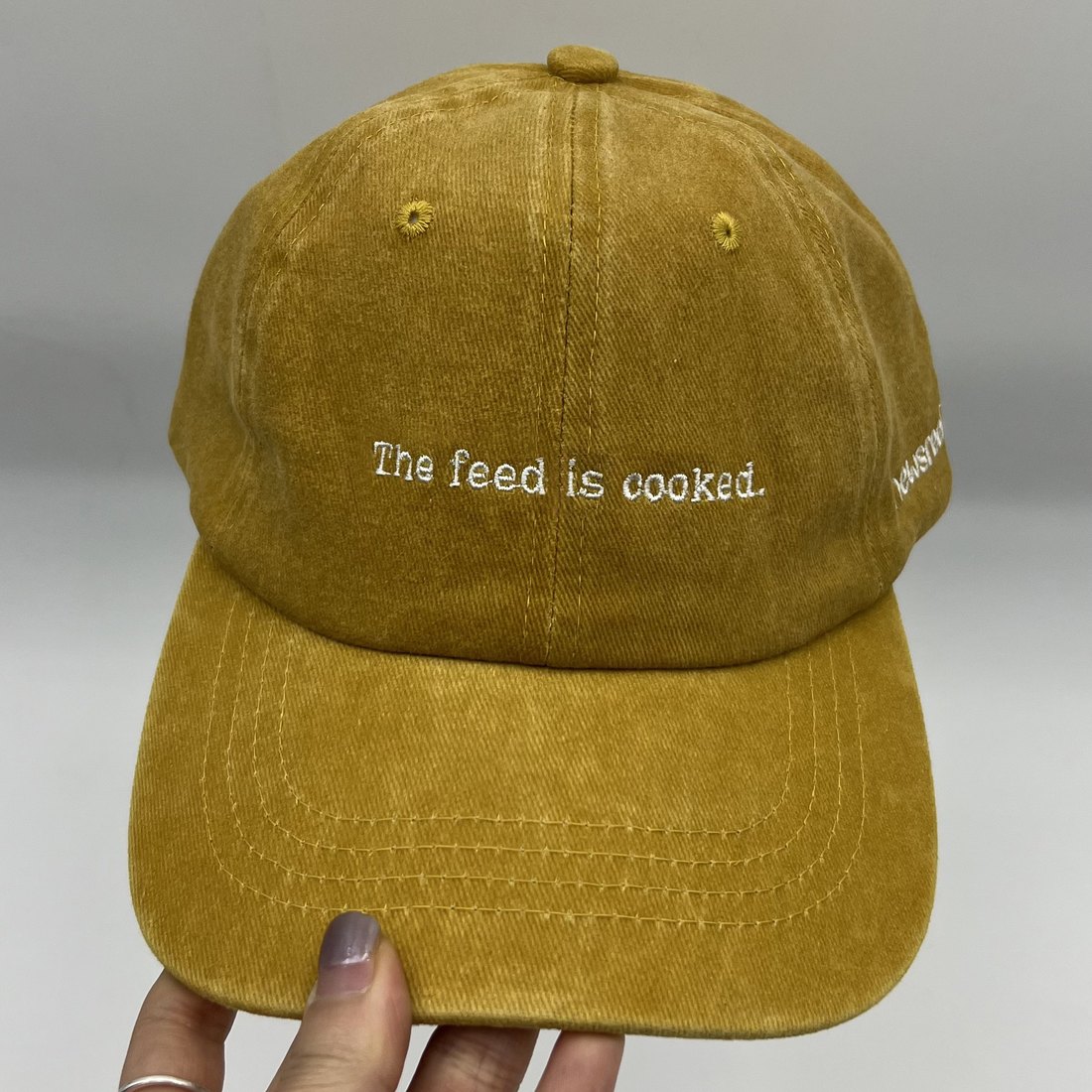 The Feed Is Cooked cap, front — embroidered 'The feed is cooked.'