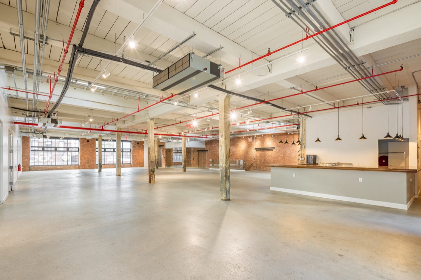 The main loft at 100 Sutton, with cast-iron columns and a bar
